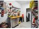 Organized garage space featuring pegboard, work bench and ample shelving for storage at 4092 Grand Park Dr, Suwanee, GA 30024