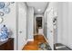 Hallway with hardwood floors, doors leading to rooms, and decorative wall hangings at 4092 Grand Park Dr, Suwanee, GA 30024