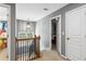 Upstairs hallway featuring carpet, gray walls, chandelier, and two visible bedroom doors at 4092 Grand Park Dr, Suwanee, GA 30024