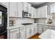 Bright kitchen featuring white cabinets, granite countertops, stainless steel appliances, and a gas stove at 4092 Grand Park Dr, Suwanee, GA 30024