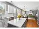 Kitchen with white subway tile and view into the dining and living areas at 4092 Grand Park Dr, Suwanee, GA 30024