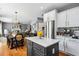 Kitchen with gray island and view into the dining and living room at 4092 Grand Park Dr, Suwanee, GA 30024