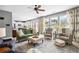 Bright living room with many windows, an open layout, and comfortable seating flowing into the dining area at 4092 Grand Park Dr, Suwanee, GA 30024