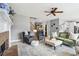 Inviting living room featuring a brick fireplace, plush seating, and stylish decor at 4092 Grand Park Dr, Suwanee, GA 30024