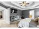 Main bedroom with tray ceilings, an exercise machine, and neutral carpeting at 4092 Grand Park Dr, Suwanee, GA 30024