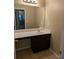 Bathroom vanity area with large mirror, neutral walls, wood cabinets and view to hallway at 4605 Fourth Rail Ln, Cumming, GA 30040