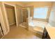 A primary bathroom featuring a soaking tub, walk-in shower, and vanity at 4605 Fourth Rail Ln, Cumming, GA 30040