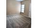 A bedroom featuring plush carpet, neutral walls, and a window with natural light at 4605 Fourth Rail Ln, Cumming, GA 30040