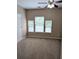 This bedroom features a ceiling fan, three windows for natural light and neutral carpet and paint at 4605 Fourth Rail Ln, Cumming, GA 30040