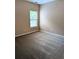 This bedroom is light and bright with neutral walls and carpet, and a window for natural light at 4605 Fourth Rail Ln, Cumming, GA 30040