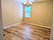 Cozy dining room with hardwood floors and elegant chandelier lighting at 4605 Fourth Rail Ln, Cumming, GA 30040