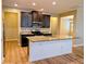 Spacious kitchen with large island, granite countertops and modern stainless steel appliances at 4605 Fourth Rail Ln, Cumming, GA 30040