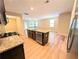 Open concept kitchen features granite island, stainless steel appliances and adjacent living area at 4605 Fourth Rail Ln, Cumming, GA 30040