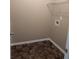 A dedicated laundry room with tiled floor and storage shelf at 4605 Fourth Rail Ln, Cumming, GA 30040