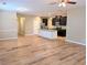 Open-concept living space with hardwood floors, kitchen island and neutral paint tones at 4605 Fourth Rail Ln, Cumming, GA 30040
