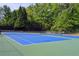 Enjoy a game of tennis on the community court, surrounded by beautiful green trees at 4605 Fourth Rail Ln, Cumming, GA 30040