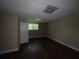 Standard basement area with a window, wood-look flooring, and a side-entry door at 554 Oak Landing Cir, Douglasville, GA 30134