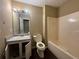 Bathroom with a single sink vanity, tile-surround bathtub-shower, and vinyl flooring at 554 Oak Landing Cir, Douglasville, GA 30134