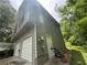 Side exterior view showing a garage, access door, and wooden deck on a two-story home at 554 Oak Landing Cir, Douglasville, GA 30134