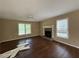Cozy living room featuring wood-look flooring, a ceiling fan, and a classic fireplace at 554 Oak Landing Cir, Douglasville, GA 30134