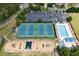 Aerial view of tennis courts, playground, community pool, clubhouse, and parking at 6317 Benbrooke Overlook Nw, Acworth, GA 30101