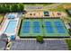 Aerial view of the community recreational center featuring tennis courts, a pool, and a playground at 6317 Benbrooke Overlook Nw, Acworth, GA 30101