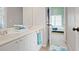 Bright bathroom featuring double sinks, white cabinets, and access to the bedroom at 6317 Benbrooke Overlook Nw, Acworth, GA 30101
