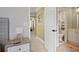 Hallway view of a full bathroom with white vanity and tiled floor at 6317 Benbrooke Overlook Nw, Acworth, GA 30101