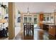 Dining room with hardwood floors, dining table, and view to living room and backyard at 6317 Benbrooke Overlook Nw, Acworth, GA 30101