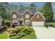 Stately brick home with beautifully landscaped front yard and attached two-car garage at 6317 Benbrooke Overlook Nw, Acworth, GA 30101