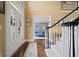 Inviting foyer with hardwood floors, staircase with white railings, and view to sitting room at 6317 Benbrooke Overlook Nw, Acworth, GA 30101