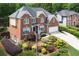 Traditional brick home with manicured landscaping, a well-maintained lawn, and inviting curb appeal at 6317 Benbrooke Overlook Nw, Acworth, GA 30101