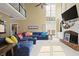 Open-concept living room with high ceilings, fireplace, and large sectional sofa at 6317 Benbrooke Overlook Nw, Acworth, GA 30101