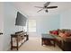 Well-lit living room with a fan, television, and a comfortable sofa at 6317 Benbrooke Overlook Nw, Acworth, GA 30101