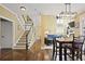 Open concept shows living room with fireplace, staircase, and dining room with hardwood floors at 6317 Benbrooke Overlook Nw, Acworth, GA 30101