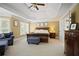Spacious main bedroom with tray ceiling, sitting area, and natural light at 6317 Benbrooke Overlook Nw, Acworth, GA 30101