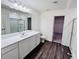 Full bathroom featuring double sink vanity, large mirror and walk-in closet at 7775 Sudbury Cir, Covington, GA 30014