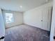 Bedroom features plush carpeting, white walls, and a window with blinds at 7775 Sudbury Cir, Covington, GA 30014