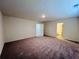 Large bedroom featuring gray carpet, neutral paint and views into the ensuite bath and closet at 7775 Sudbury Cir, Covington, GA 30014