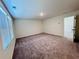 Bedroom features large windows for natural light and neutral walls with gray carpet at 7775 Sudbury Cir, Covington, GA 30014