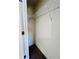 Storage closet with a wire rack shelf for hanging or folded clothing at 7775 Sudbury Cir, Covington, GA 30014