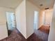 Hallway with carpet and doors to several bedrooms and bathrooms at 7775 Sudbury Cir, Covington, GA 30014