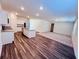 Open concept kitchen and living space with hardwood floors, kitchen island, carpet and ample light at 7775 Sudbury Cir, Covington, GA 30014