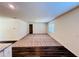 Spacious living room featuring plush carpeting, a large window, and open access to the kitchen area at 7775 Sudbury Cir, Covington, GA 30014