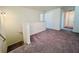 Open loft area with gray carpet and white railing overlooking the staircase at 7775 Sudbury Cir, Covington, GA 30014