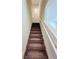 Staircase with gray carpet and white railing leads to the upper level of the home at 7775 Sudbury Cir, Covington, GA 30014