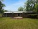 Large backyard featuring a brick home, a patio, and mature trees at 2060 Devore Sw Dr, Marietta, GA 30008