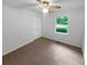 Cozy bedroom with neutral carpet, ceiling fan, and a window providing natural light and backyard views at 2060 Devore Sw Dr, Marietta, GA 30008