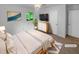Bright bedroom featuring a neutral palette, carpeted floors, and a picture window overlooking the backyard at 2060 Devore Sw Dr, Marietta, GA 30008