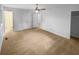 Spacious bedroom featuring carpeted floors, a ceiling fan, and an adjacent door leading to the bathroom at 2060 Devore Sw Dr, Marietta, GA 30008